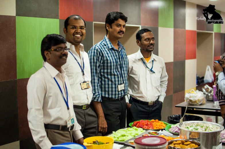 a group of people in front of a table covered with food