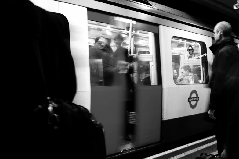 a man and woman standing by a train