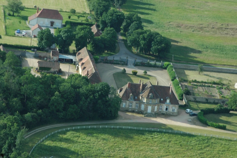 an aerial s of a house and surrounding trees