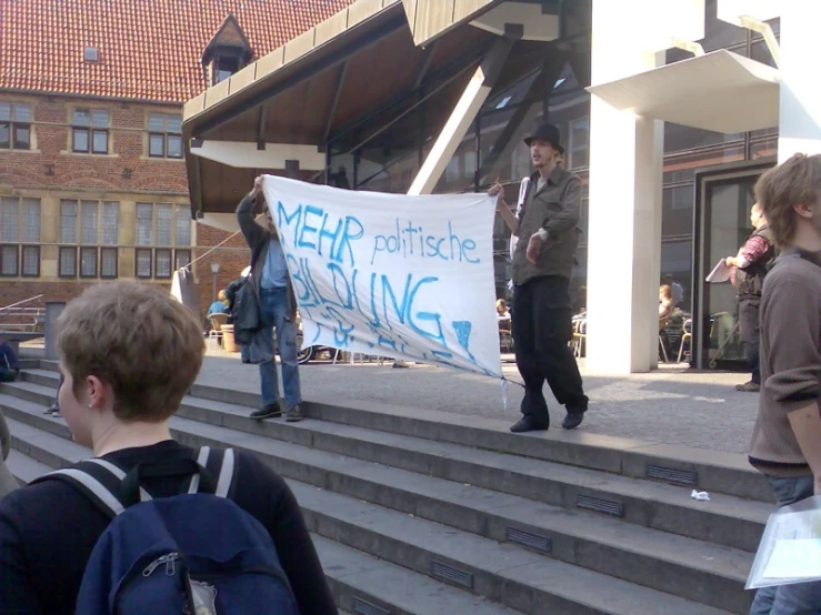 a protest in front of a building with people protesting