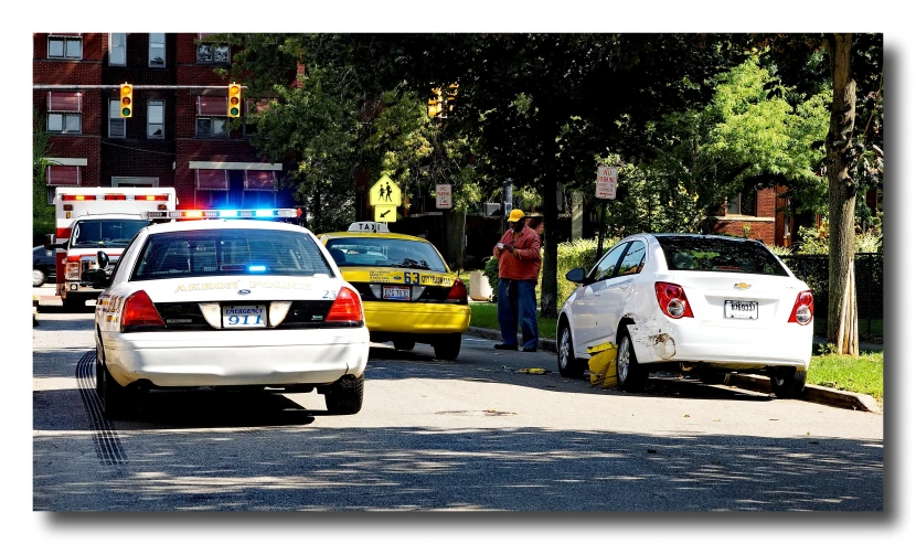 an ambulance car and police cars on the side of the road