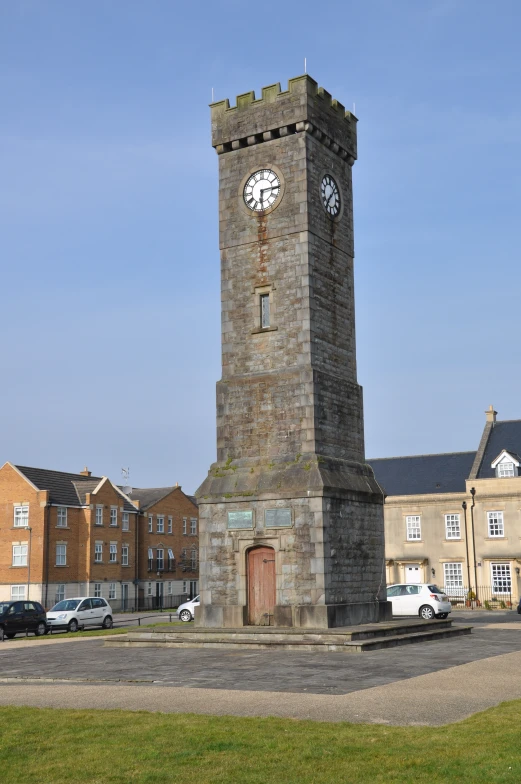 a clock tower sitting in the middle of a lot