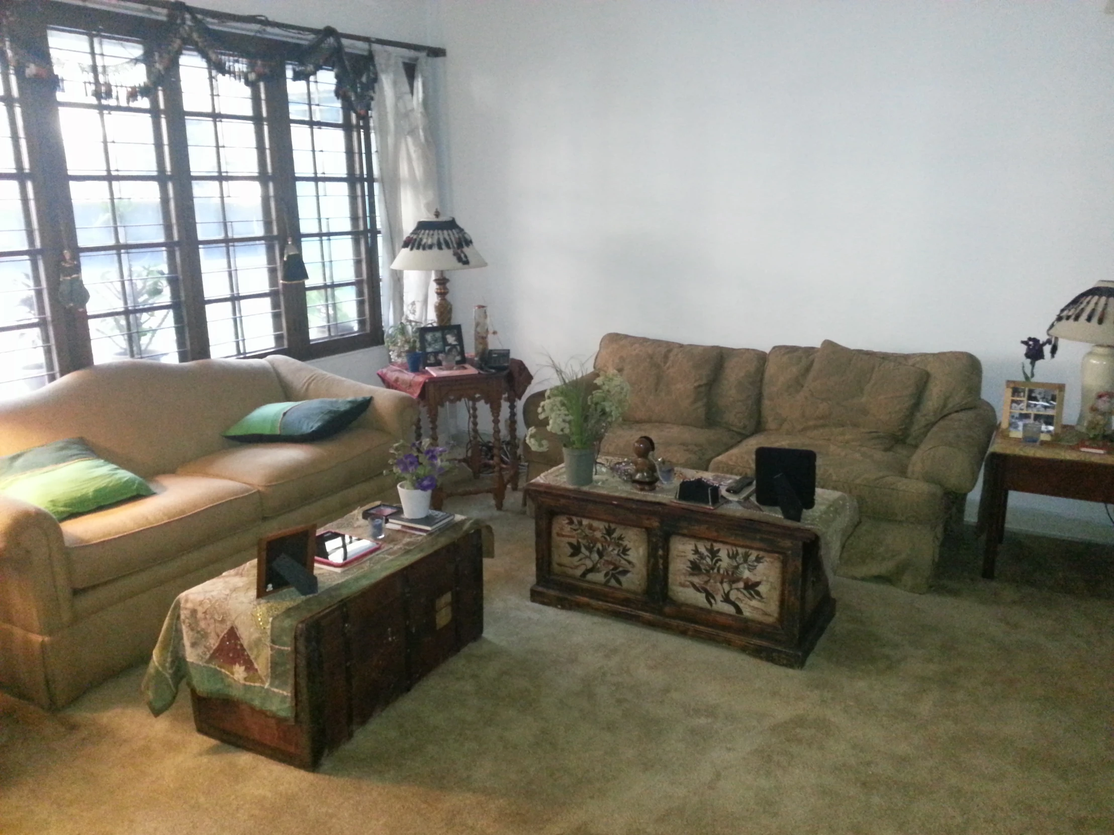 a living room with white walls and tan carpet