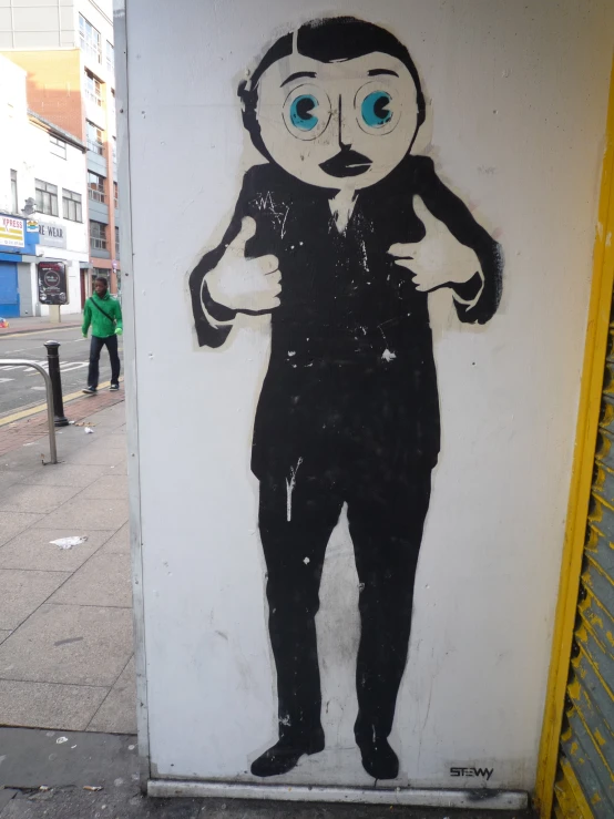 a drawing on a wall of a man with big blue eyes