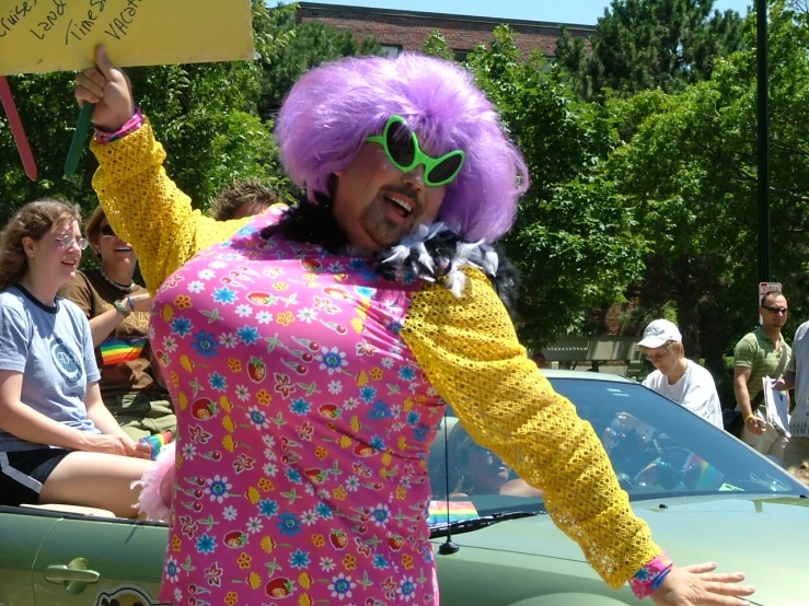 a woman in a clown wig with glasses and a pink top