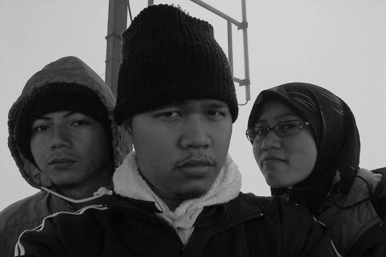 three people with hats and a black jacket