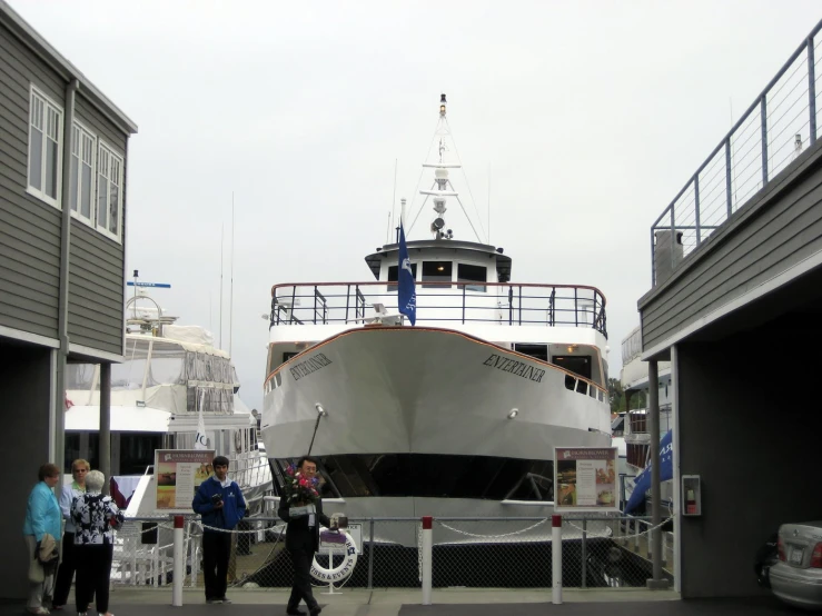 a white and blue boat in the middle of a dock