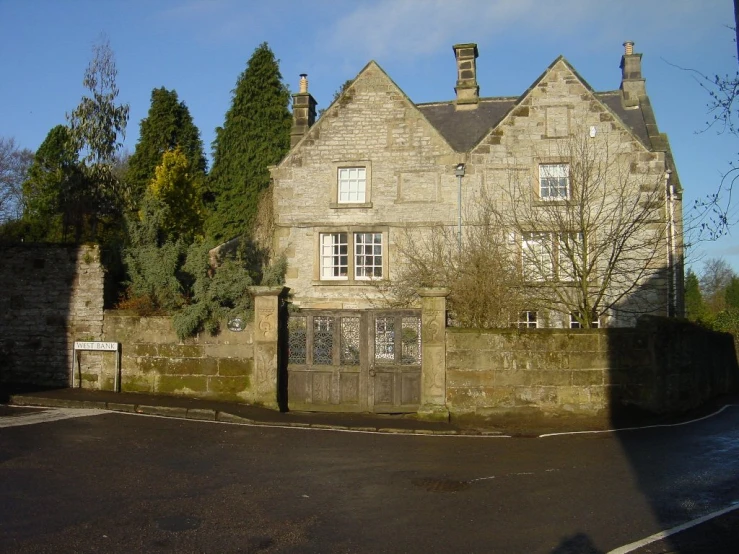 an old home sitting on the corner of a street