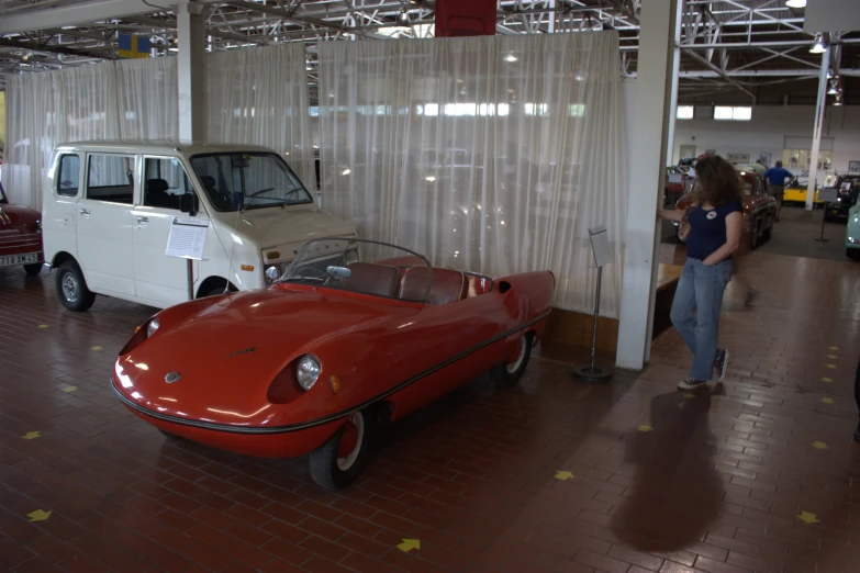 people and vehicles in a big show room