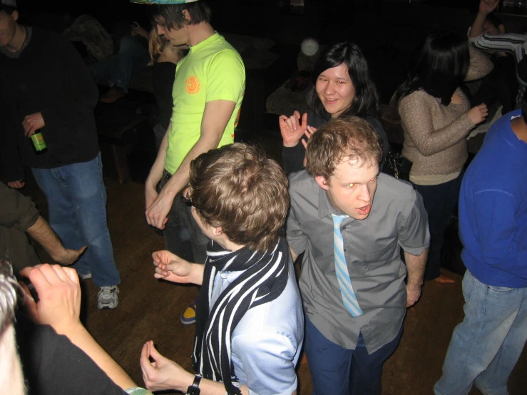 a group of people dancing on a wooden floor