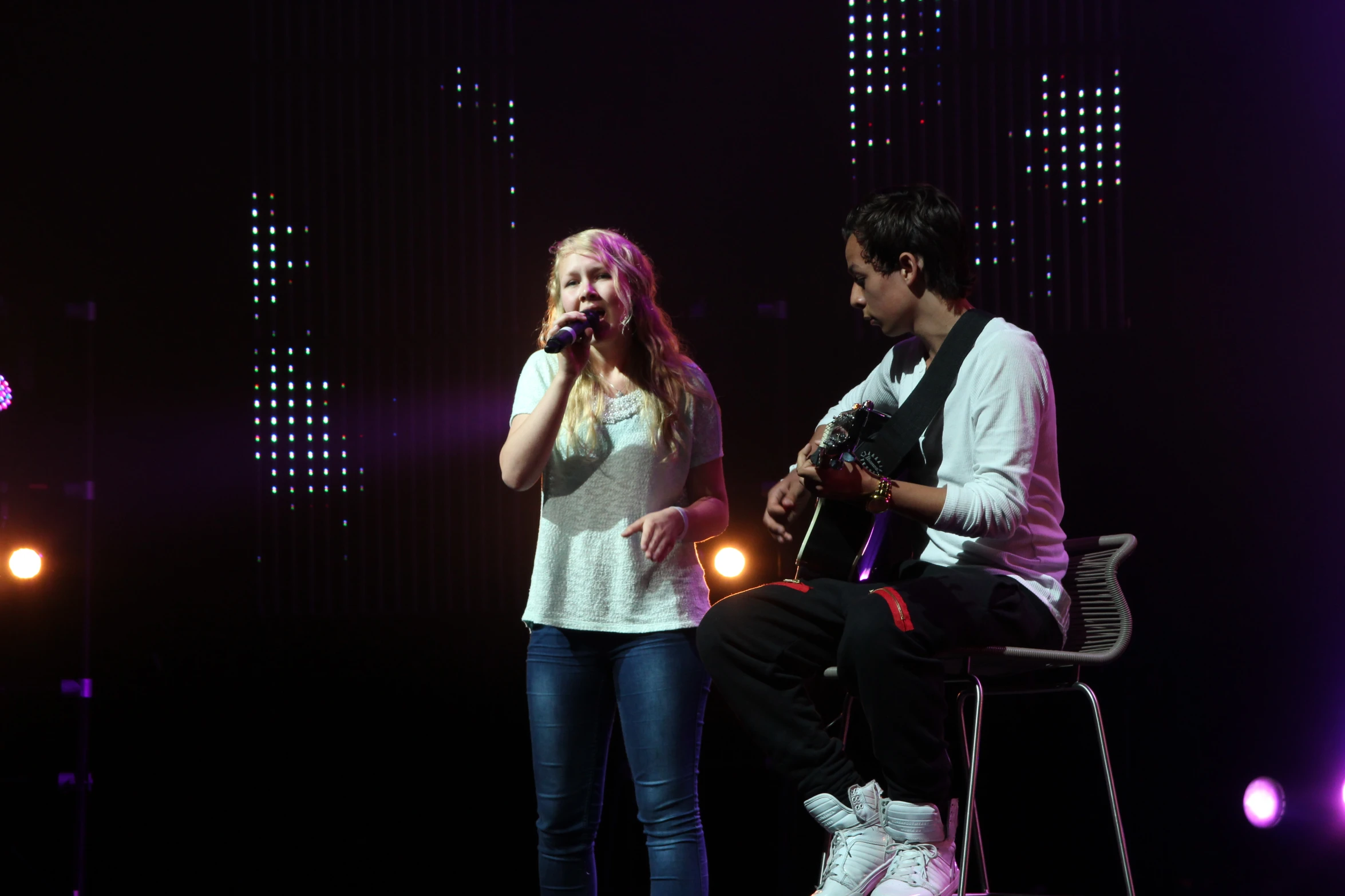 a man and woman are on stage together