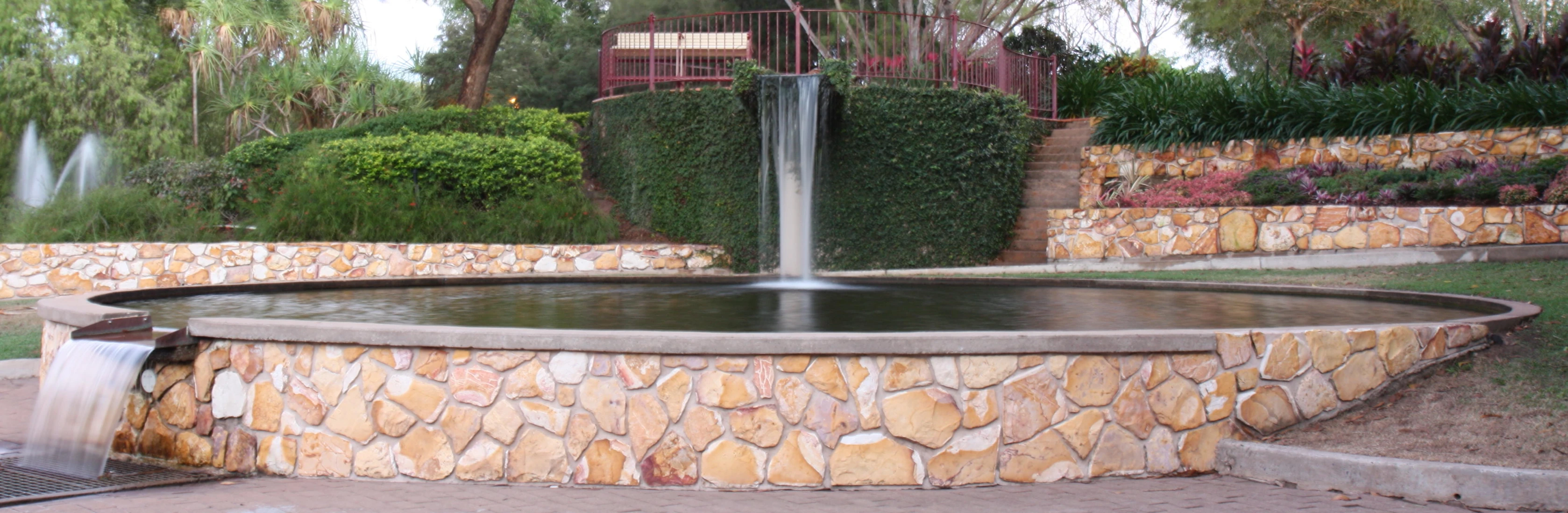 this is a water fountain on the side of a building