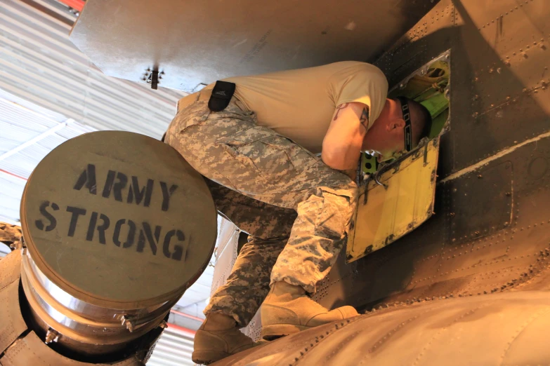 a man in a military uniform climbing up the side of an aircraft