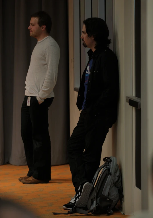 two men standing in the doorway waiting for soing