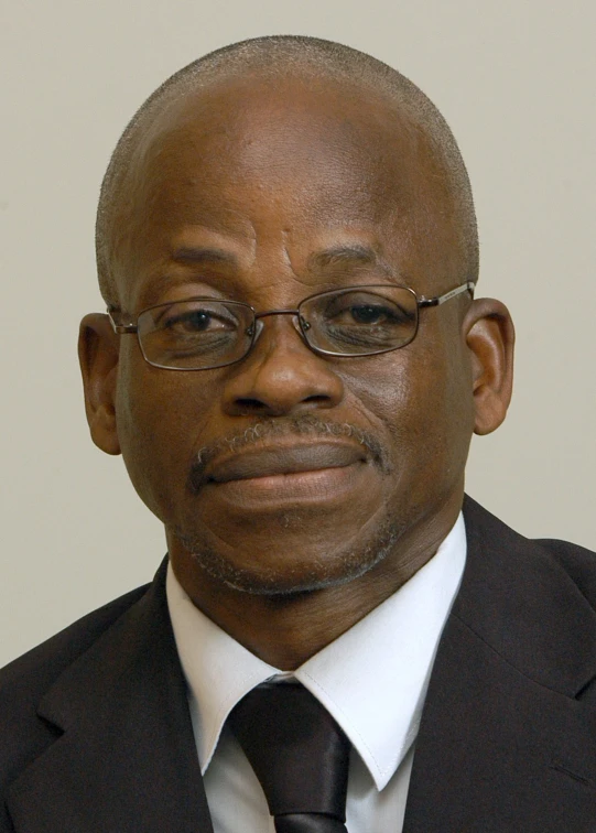 an african man wearing glasses and a tie