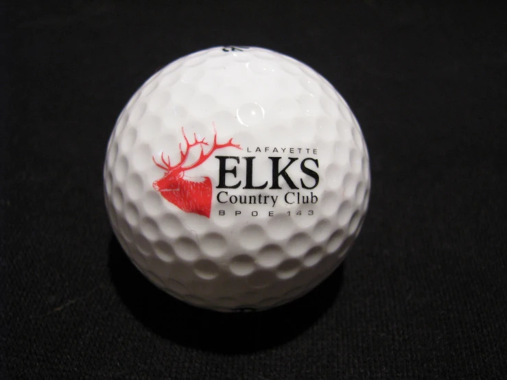 closeup of golf ball, with elk logo on back