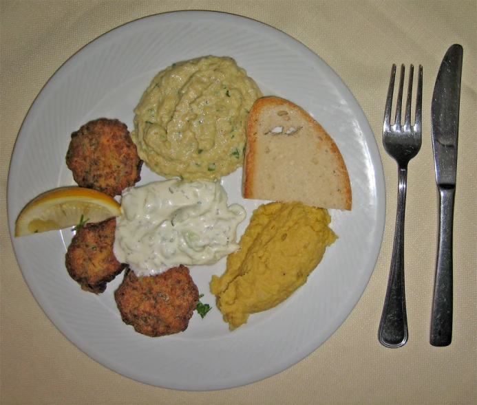 a plate topped with bread and other food