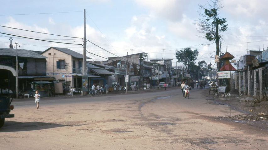 an intersection with people and vehicles in the distance