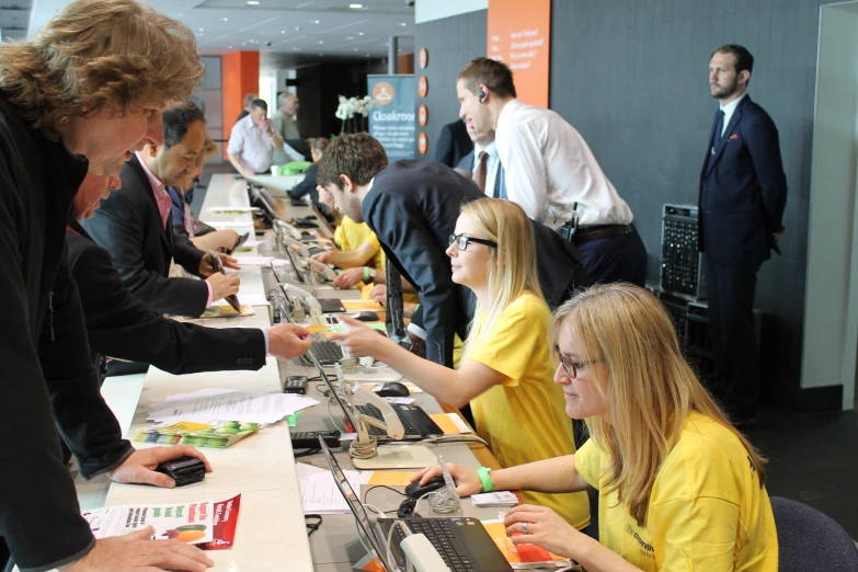 a group of people sitting at a long counter