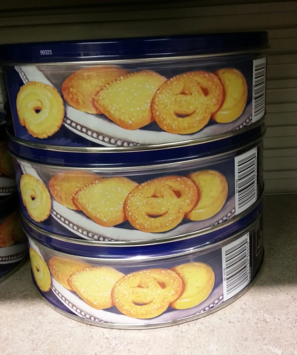 three food containers filled with onion rings and an orange inside
