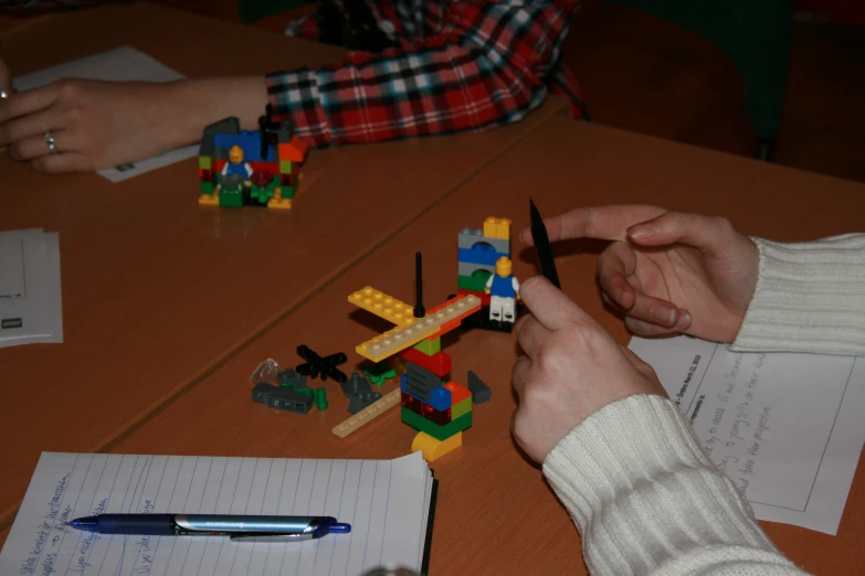 two children building a model with their hands