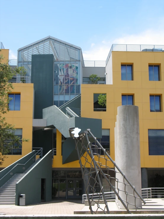 staircases in front of yellow building with blue sky