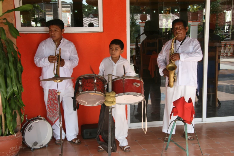 two men play music with s and children