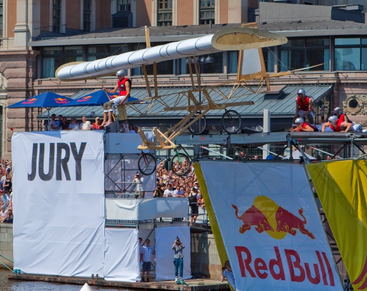 a man doing tricks on top of a red bull boat