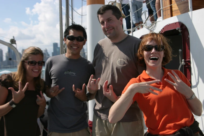 a group of friends posing on the deck of a boat