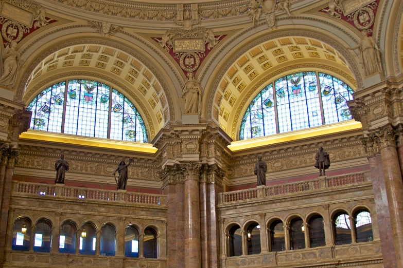 a fancy room filled with statues and glass windows