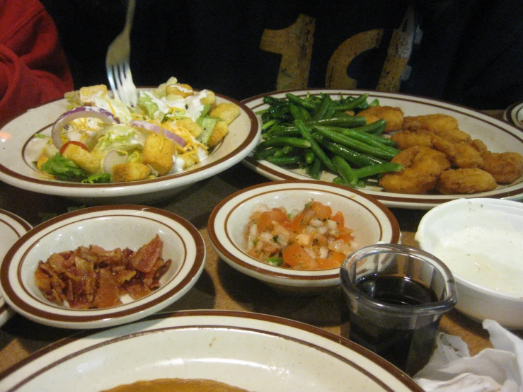 a table topped with plates of food and bowls