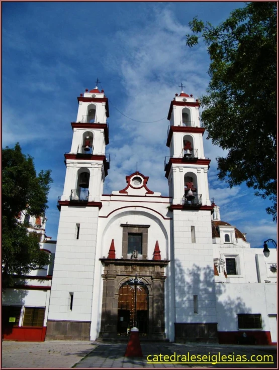 the large white building has two towers on top