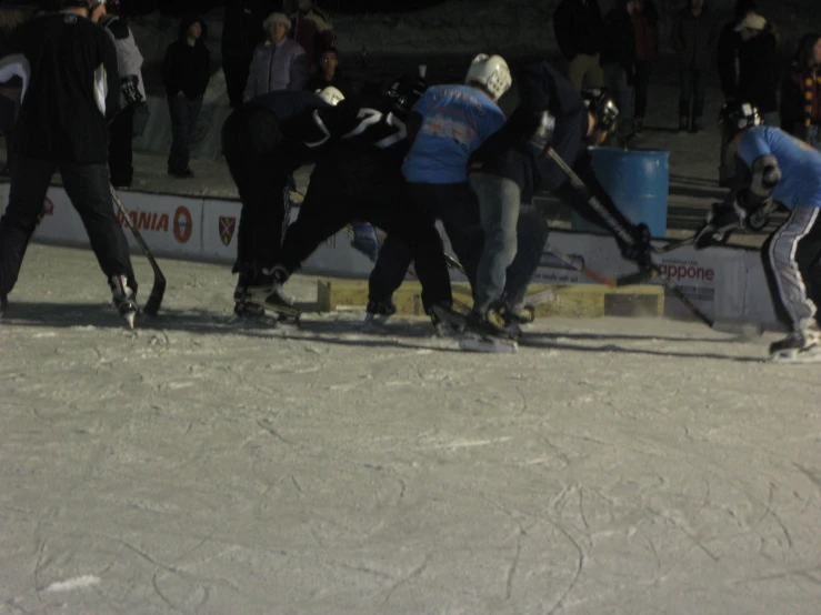 group of people skating on a course while others watch