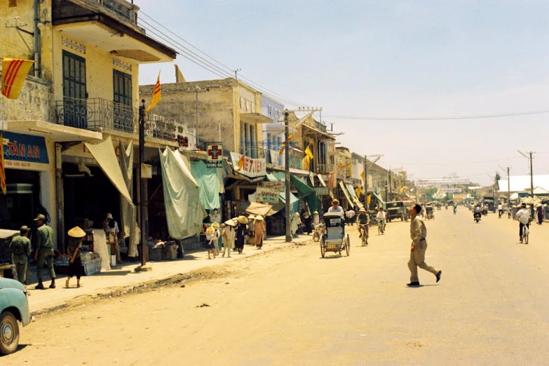 an image of a street scene with pedestrians and motorcycles