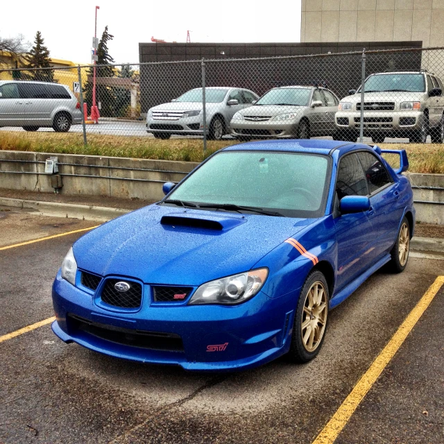 a blue subarued subarun parked in a parking lot