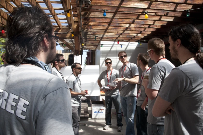 men standing around and talking with one another