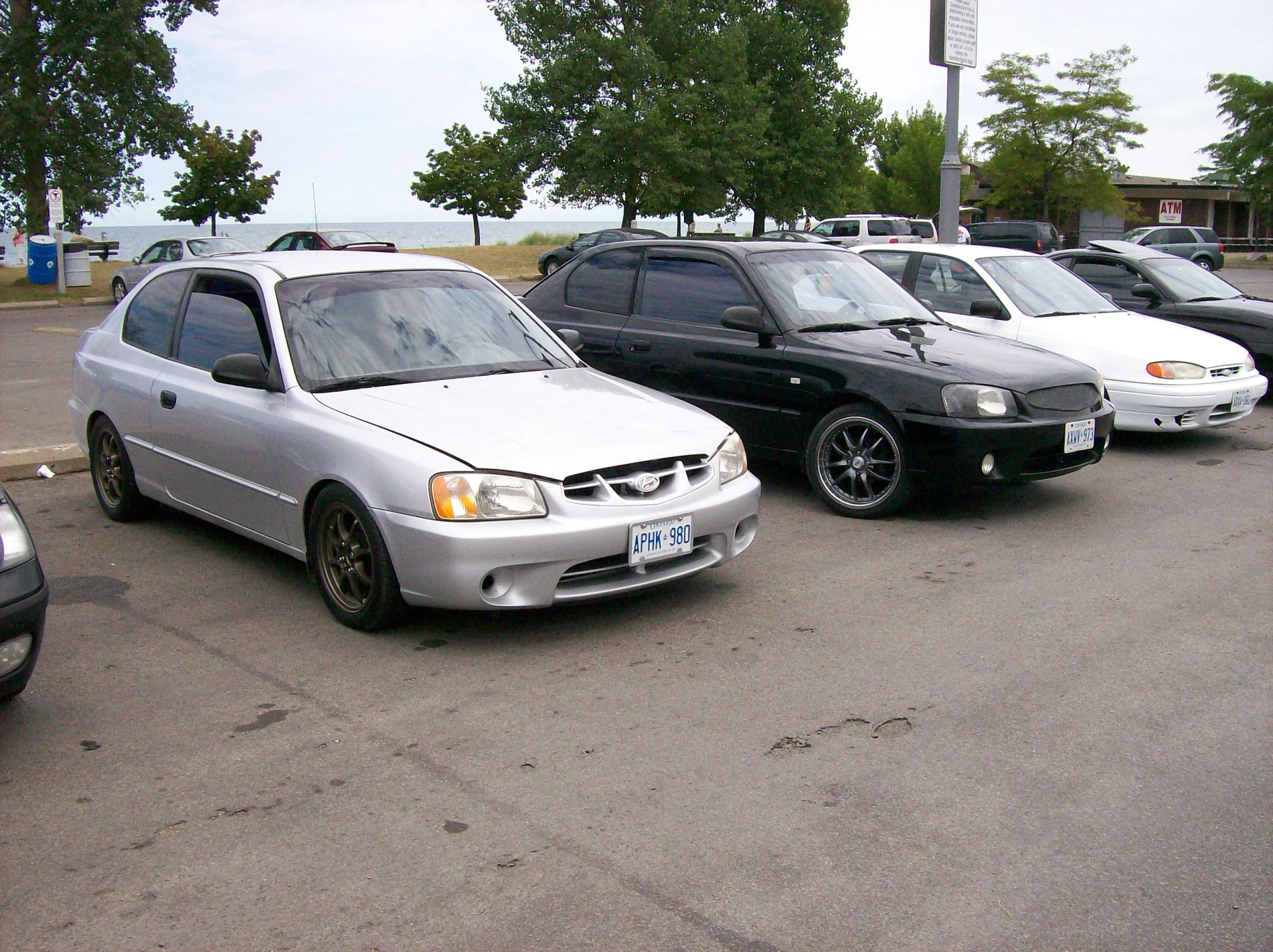 three parked cars are lined up in a parking lot