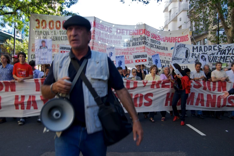 some men holding megaphones and a banner