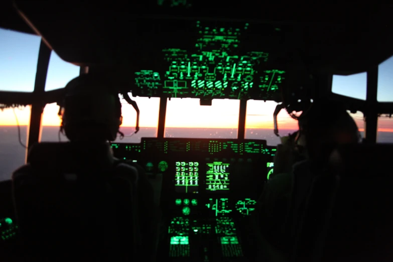 the view from a cockpit in an aircraft at sunrise