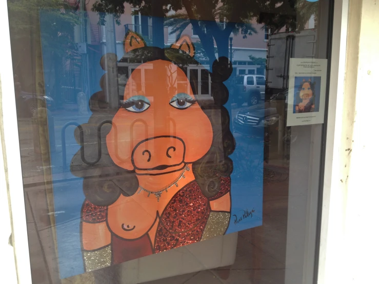 the large painting on the window of a store front displays a woman's face