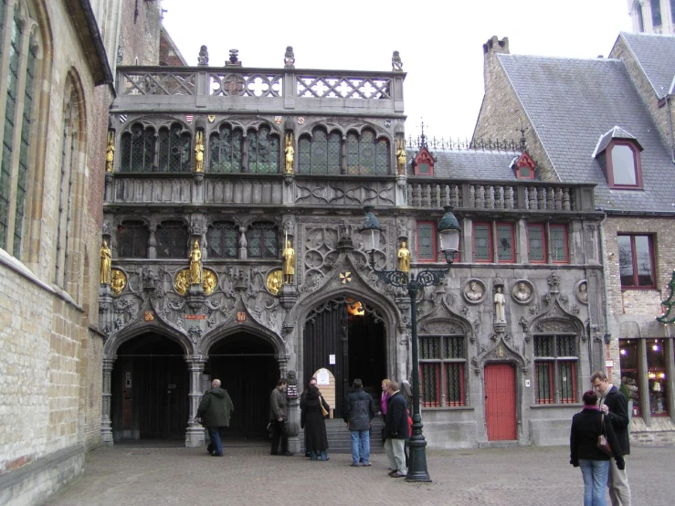 tourists look on from the entrance to a beautiful gothic - style building