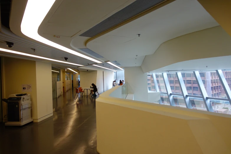 a hallway in an office building with people walking in it