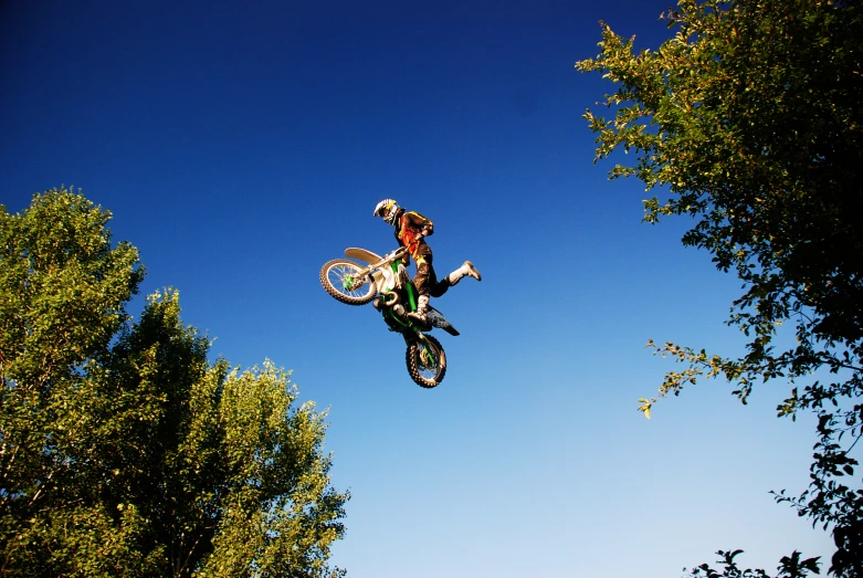 someone on a bike is mid air doing a trick
