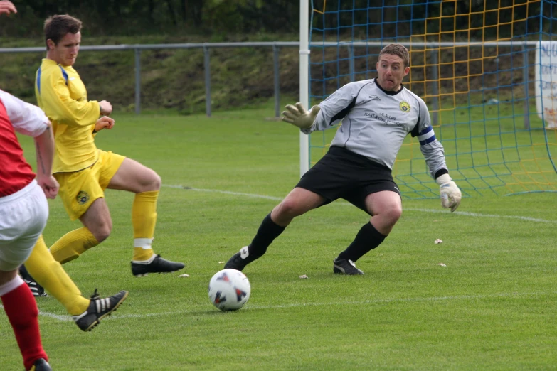 a couple of men on a field with a soccer ball