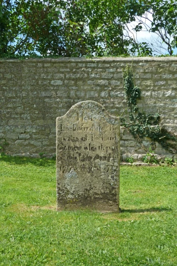 the stone monument stands in the middle of the yard