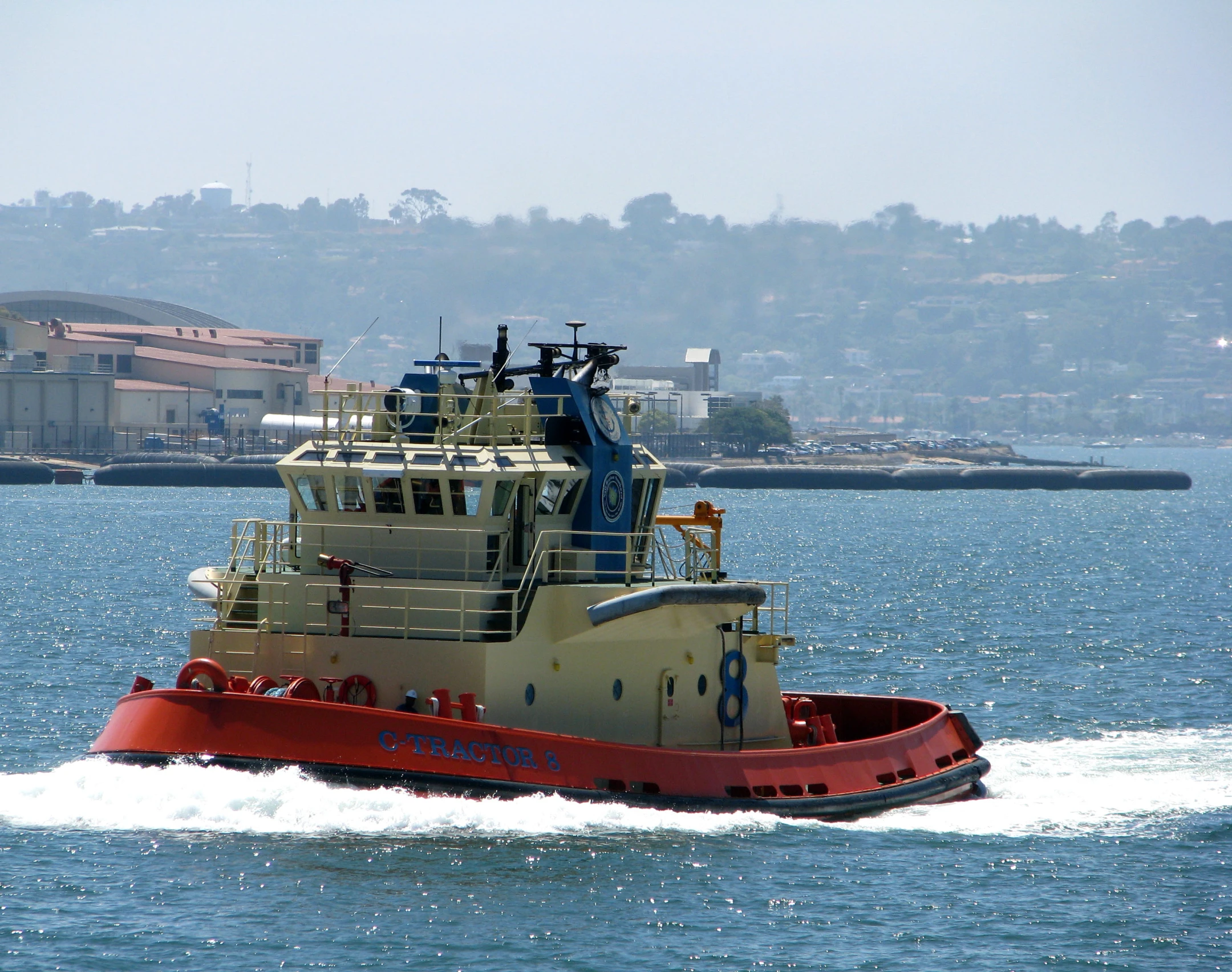 a boat in the water moving toward shore