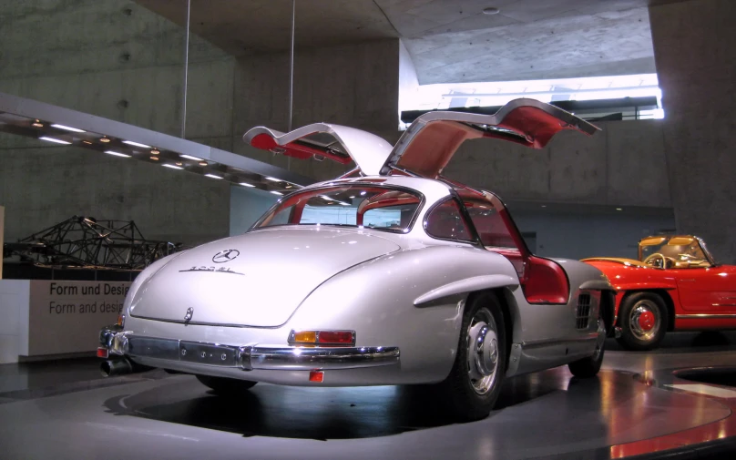 an automobile is displayed in a museum, with a large window