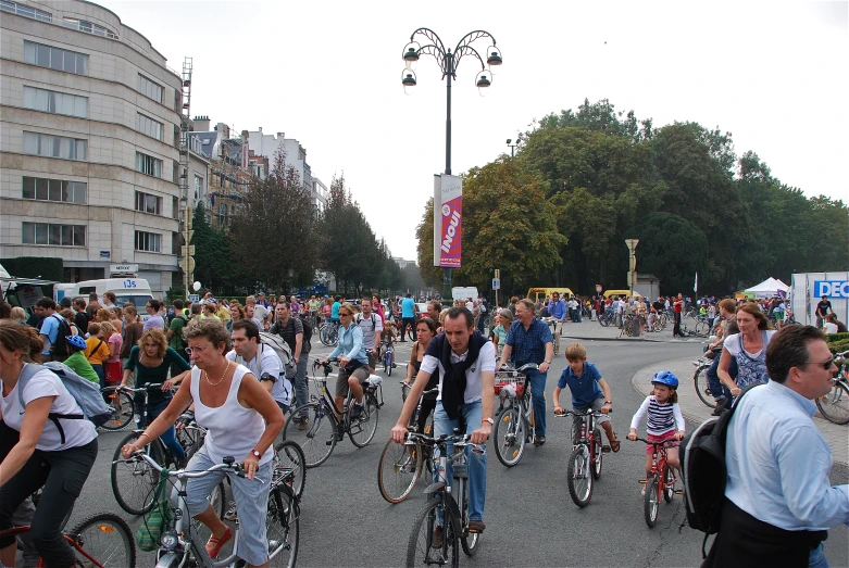 people in a street riding their bikes on the road