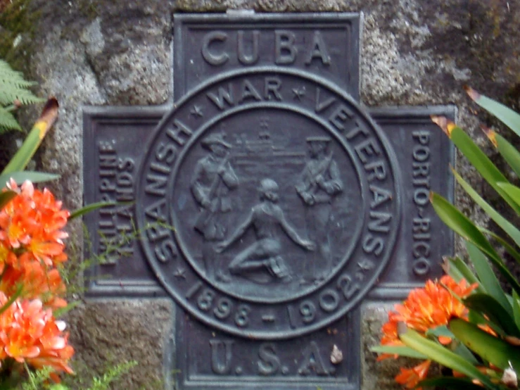 the sign on the side of a building in front of flowers