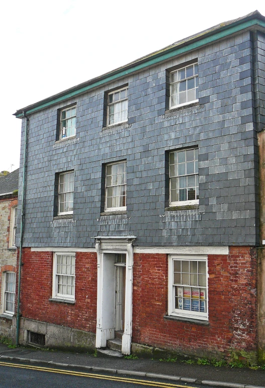 a large blue building on the side of the street